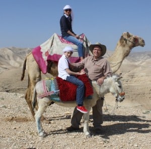 family on a camel and donkey Judean Desert